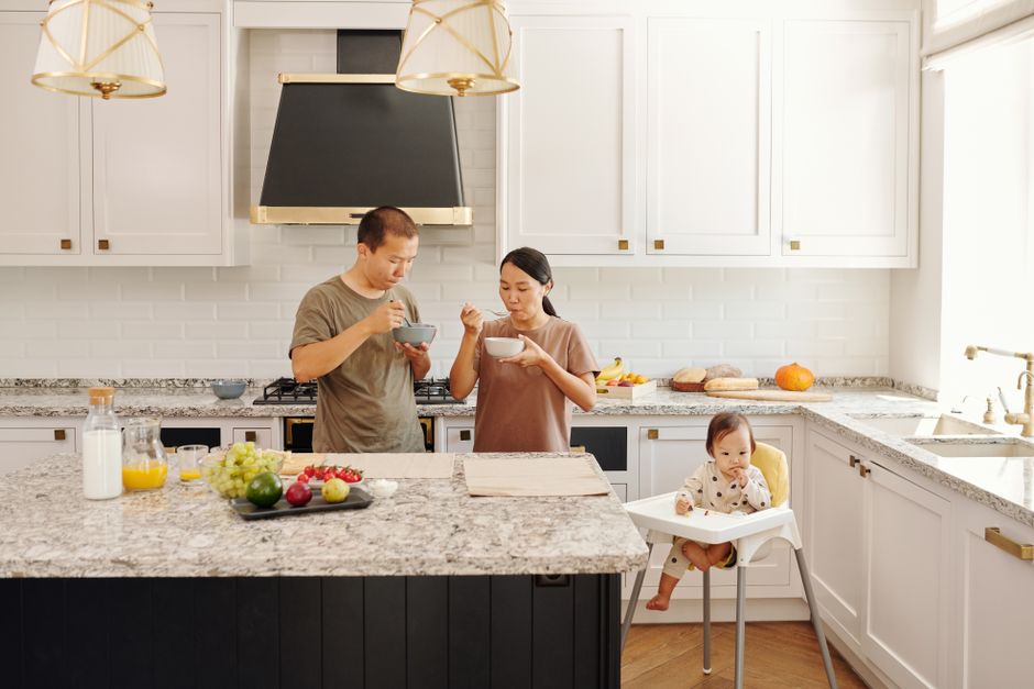 Kitchen with a stone countertop, cabinets and a dining area.
